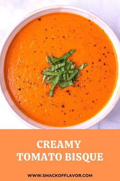 a bowl of creamy tomato bisque with green onions on top and the words creamy tomato bisque above it