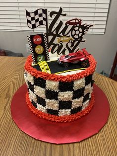 a car themed birthday cake on top of a table