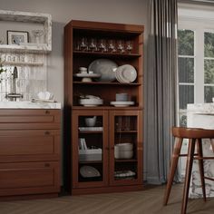 a kitchen with wooden furniture and white walls