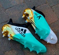 the adidas soccer cleats have been designed to look like gold and turquoise