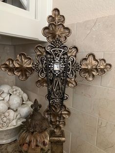 an ornate cross is on display in the kitchen