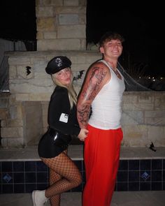 two people standing next to each other with tattoos on their arms