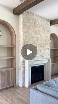 a living room with a fireplace and built in shelves