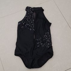 a black bodysuit with silver sequins on it