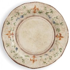 an antique china plate with flowers and butterflies on the rim, isolated against a white background