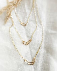 The Paperclip Collection is a simple a dainty and elegant everyday necklace that comes in your choice of 1-3 interlocking links. Each link is made from Sterling Silver or 14K Gold Filled wire that has been hand forged to shape and soldered closed.   Perfect gift for mom's who love to represent each child with a symbol of a heart.  - 14K Gold Filled or Sterling Silver approx: 16" chain + extension for adjustability   - 14K Gold Filled or Sterling Silver handmade link pendants - Choose from 1-3 interlocking links Your Paperclip Necklaces is Handmade in Truckee, Lake Tahoe California All Designs, Copyright © 2025  Nox Jewelry Paperclip Necklaces, Paperclip Jewelry, Gold Paperclip Necklace, Link Jewelry, Gold Link Necklace, Tahoe California, Paperclip Necklace, Lake Tahoe California, Gold Link