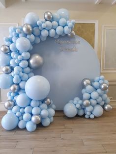 blue and silver balloons are arranged in the shape of a wreath