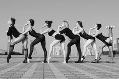 a group of women in leotards posing for a photo with their legs spread out