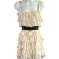 This charming Forever 21 dress combines delicate lace with playful ruffles, creating an elegant yet youthful look. The peach/ivory lace over black accents offers a striking contrast, ideal for making a statement. Its medium size provides a comfortable fit, while the spaghetti straps add a feminine touch.  The beading on the straps are in good shape with the exception of one spot.  The beads are intact...just needs a couple of stitches to tack down the beads.  There is also some separation at the bottom of the zipper that needs a few stitches on each side.  Price reflects condition. * Medium size for a comfortable fit   * Lace ruffles for an elegant look   * Black waistband for contrast   * Spaghetti straps for style   * Ivory color for versatility Style: Eyelash Lace, Whimsigoth, Retro Sty Ruffle Tiered Dress, 21 Dress, Wakefield, Medium Dress, Lace Ruffle, Dress Medium, Retro Stil, Tiered Dress, Boutique Dresses