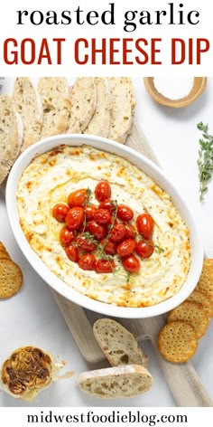 a bowl of roasted garlic goat cheese dip with tomatoes and crackers on the side