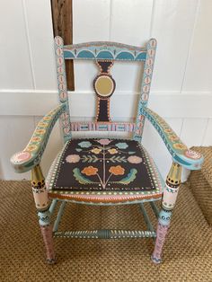 an ornately decorated wooden chair sitting in front of a door