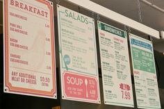 several menus hanging on the wall in a restaurant