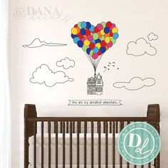 a baby's room with a crib and wall decal