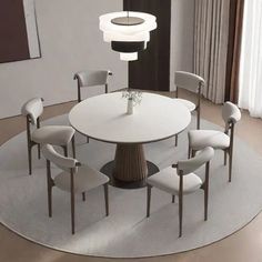 a round dining table with six chairs around it