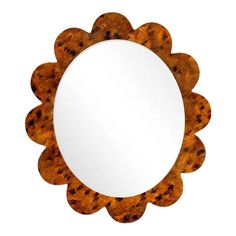 a round mirror sitting on top of a white wall