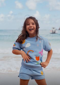 Description Brighten up your child's day with the Happy Daisy Set! This charming set includes a sky blue t-shirt and matching shorts, both adorned with colorful, playful patches such as smiling suns, vibrant rainbows, and cheerful daisies. The lightweight, breathable cotton ensures comfort during all-day play, while the fun embellishments spark joy and imagination. Ideal for sunny days out or imaginative play at home, this set is designed to keep your little one happy and stylish. Material & Car Playful Summer Sets With Character Print, Spring Cartoon Print Playwear Set, Playful Floral Print Playtime Sets, Playful Summer T-shirt With Character Print, Playful Summer Playwear For Babies, Crystal Hoodie, Cheerful Daisy, Joyful Design, Sequin Hoodie