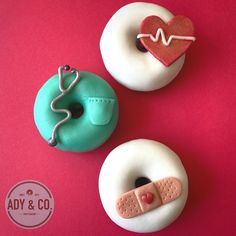 two donuts with icing and stethoscopes on them sitting next to each other