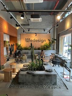 the interior of a modern office building with plants and people sitting at their desks