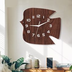 a large wooden clock with numbers on the face is shown in this living room setting