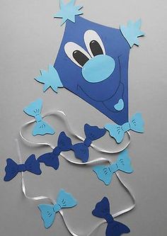 blue paper cut out of the shape of a kite with bows and stars on it