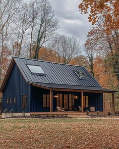 a blue house with a metal roof in the fall