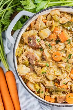 a pot full of stew with carrots and celery next to some parsley