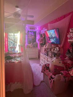 a bedroom decorated in pink and white with lots of stuffed animals on the dressers