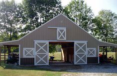 a large barn with two stalls on the side