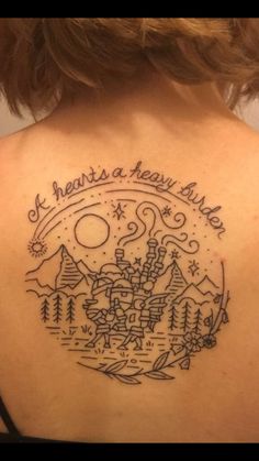 the back of a woman's shoulder with a tattoo on it