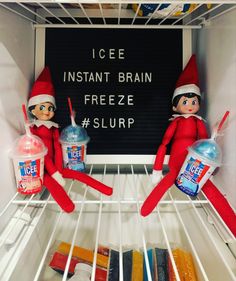 two elfs are in the refrigerator with ice and water