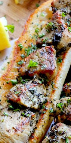 grilled fish with herbs and lemons on a cutting board