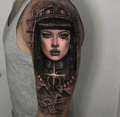 a woman with an egyptian head tattoo on her arm