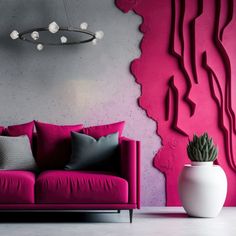 a pink couch sitting in front of a purple wall