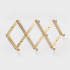 three wooden pegs are hanging on the wall