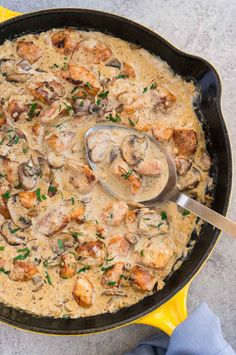 a skillet filled with shrimp and mushrooms