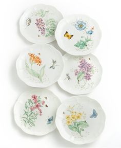 six plates with flowers and butterflies painted on them