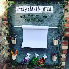 there is a sign that says every child is an artist on the side of a building