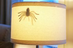 a lamp with a spider shadow on it