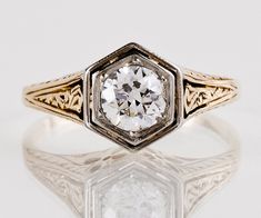 an antique style diamond ring with filigrees