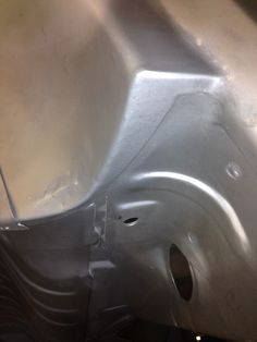 the bottom part of a car that has been painted silver