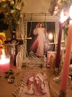 a table with candles and pictures on it