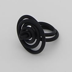 This fun and fashionable ring is unlike anything you'll find in your jewelry box! Made with wire and black rubber tubing, this ring is hand twisted to create a unique design. The tubing keeps this ring super lightweight and the wire makes it easily adjustable to fit any size. This ring will stand out on its own, or complete you can pair it with your favorite necklace! Care Instructions: Remove jewelry when applying perfumes, creams, washing hands etc. Do not store in direct sunlight. to restore Unique Black Spiral Jewelry, Adjustable Spiral Ring With Modern Twist, Adjustable Spiral Ring With A Modern Twist, Adjustable Spiral Rings With A Modern Twist, Something To Talk About, Funky Rings, Funky Necklace, Silicone Ring, Unusual Rings