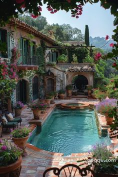 an outdoor swimming pool surrounded by potted plants and flowers in front of a house