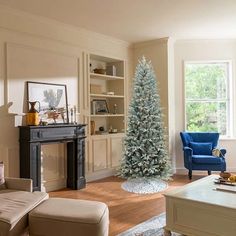 a living room filled with furniture and a christmas tree in the middle of the room