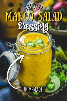 the recipe for mango salad dressing is in a glass jar with an arrow pointing to it