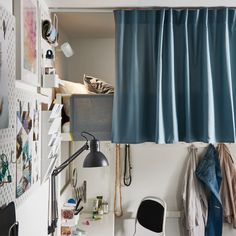 a desk with a lamp, chair and pictures on the wall