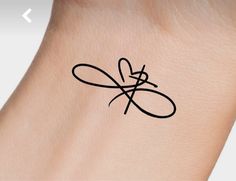 a small tattoo on the wrist of a woman's arm with an infinite symbol