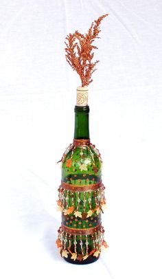 a bottle that has some kind of decoration on it's top and is filled with beads