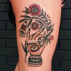 a close up of a person's leg with a tattoo on it and flowers