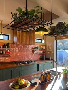 a kitchen filled with lots of counter top space next to a large open window and potted plants